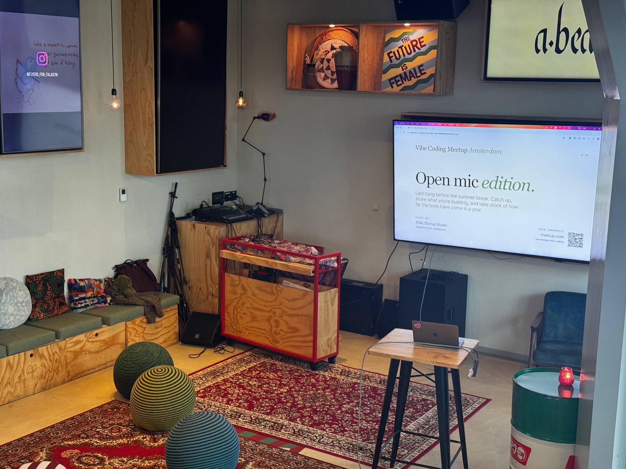 The presentation area prepared for the Vibe Coding Open Mic, with the event title displayed on screen.