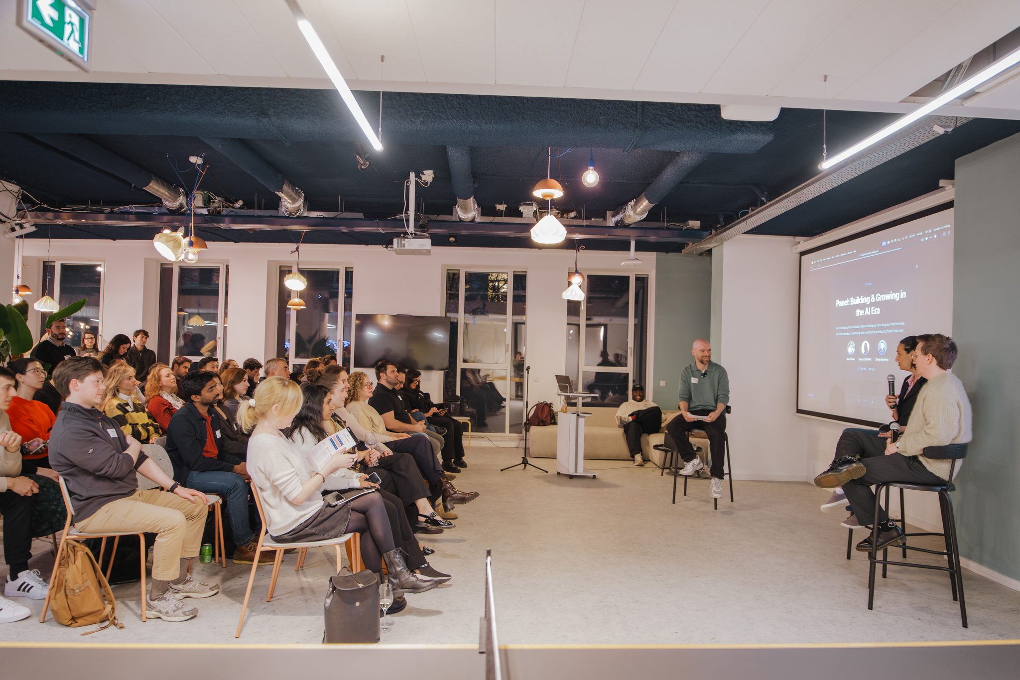 A fireside conversation in front of a seated audience during the Amplitude community event in Amsterdam.