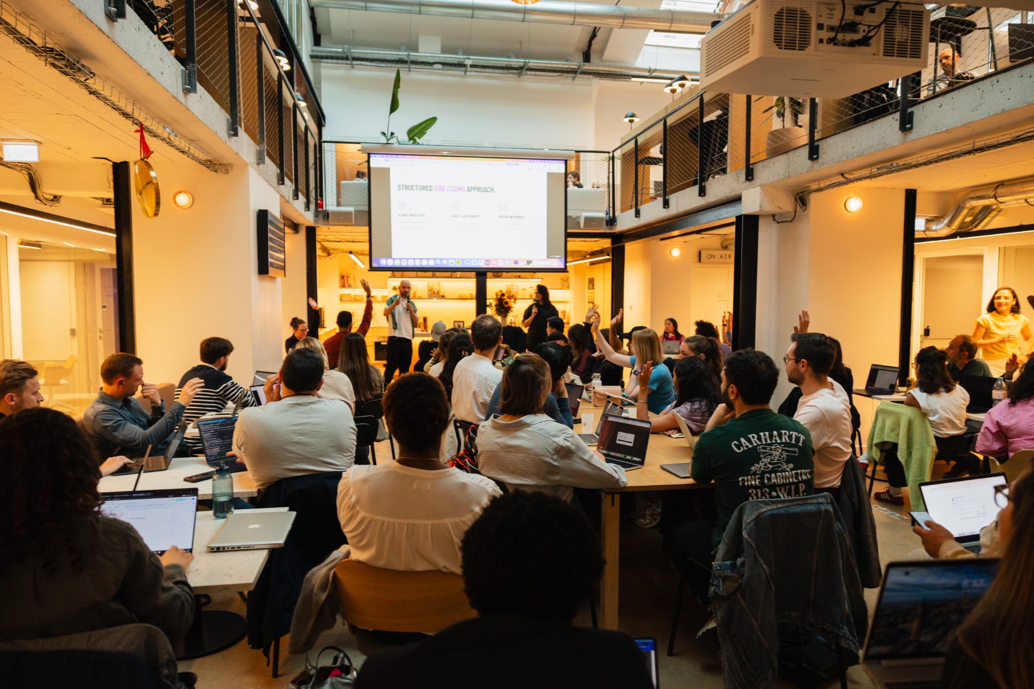 Participants raising their hands during the workshop in Paris.