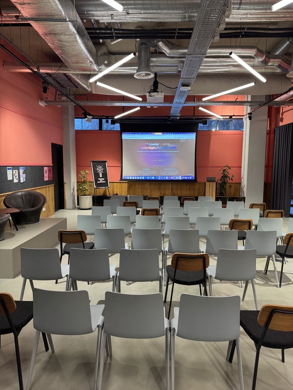 Rows of chairs facing the presentation screen before the Vibe Coding Demo Night — EU-INC Edition in Amsterdam.