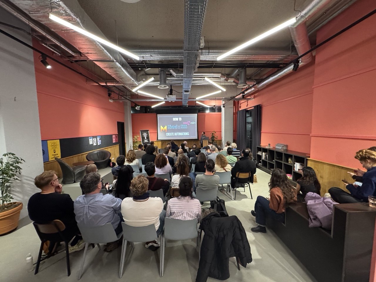 Attendees watching a live automation demonstration at the Vibe Coding Demo Night — EU-INC Edition in Amsterdam.