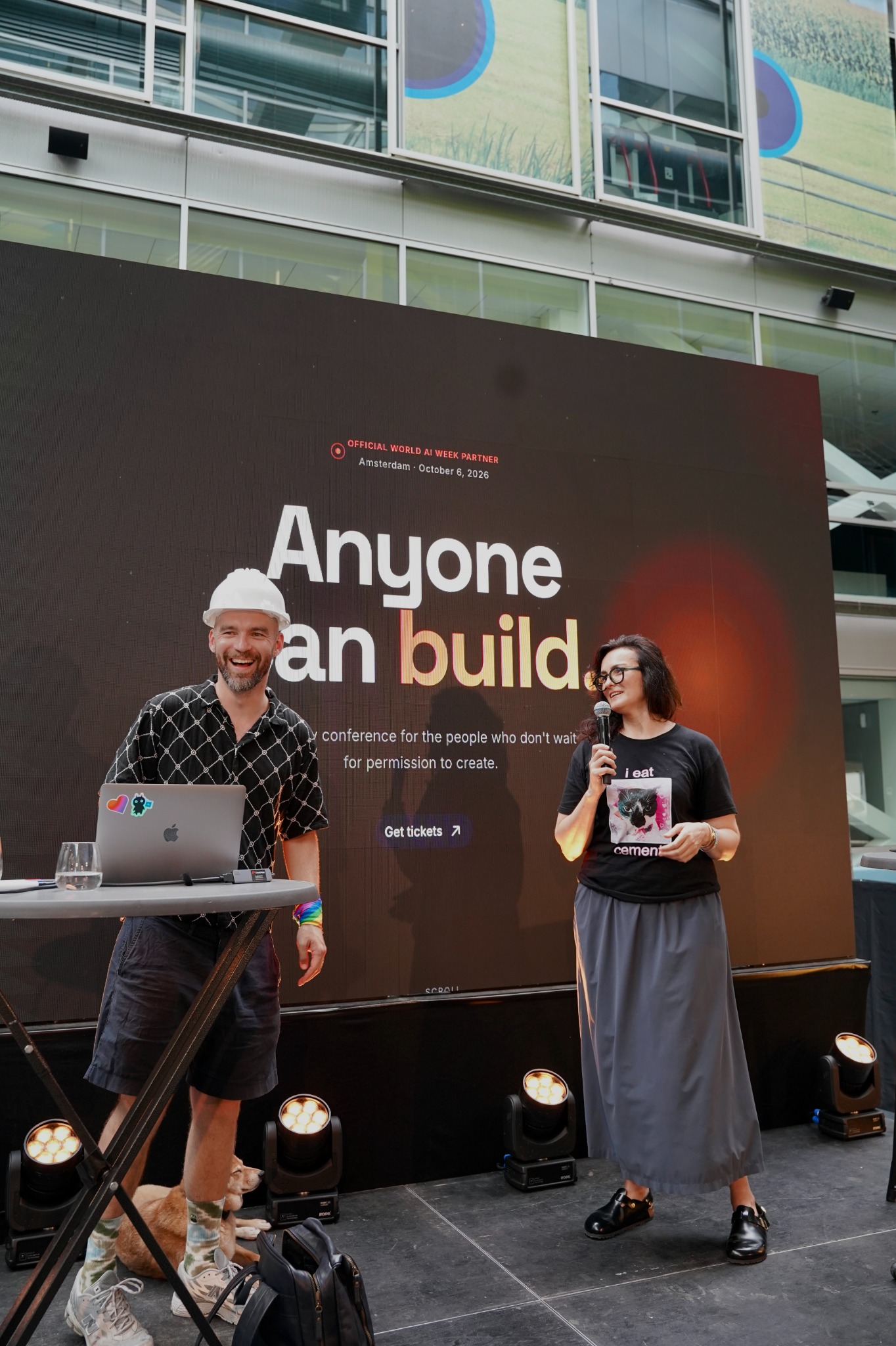 Dima Abramov and Elena Avramenko on stage in front of a screen reading Anyone can build.
